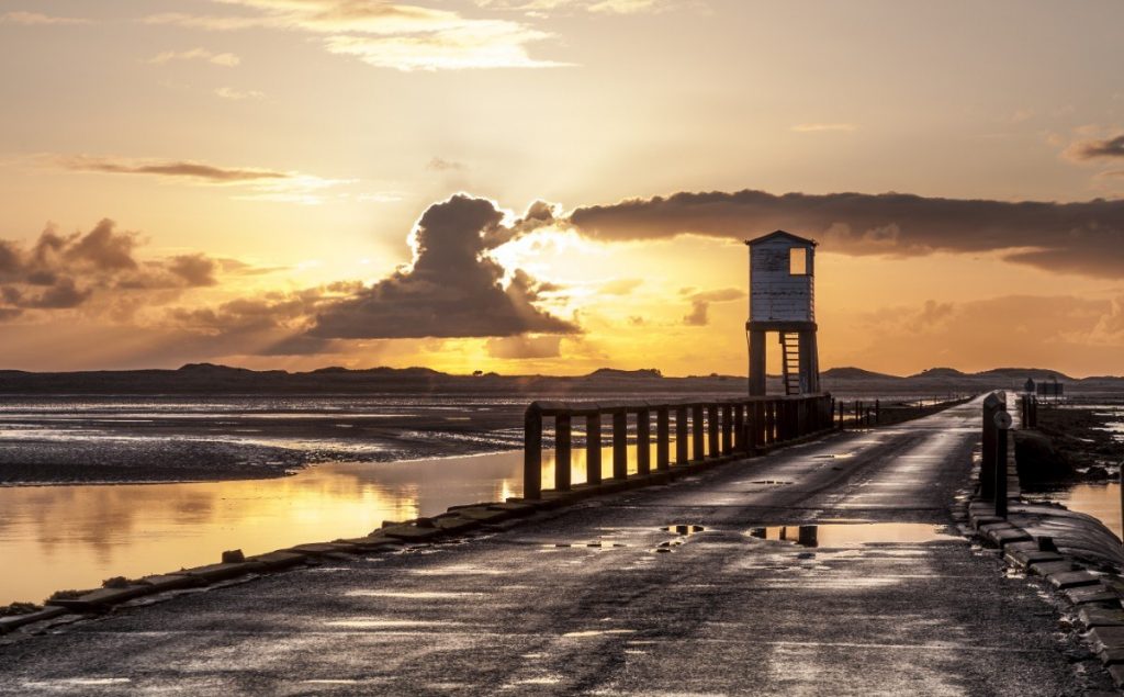 Východ slunce na pobřeží ostrůvku Holy Island.